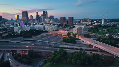 Aerial-approaching-shot-of-traffic-in-Atlanta-City-with-Skyline-during-blue-hour,-Georgia