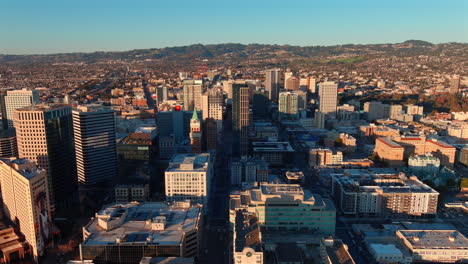 Oakland,-California-city-skyline-at-sunset---sliding-aerial-reveal