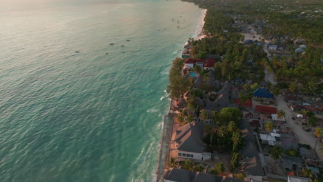 Aerial-view-of-tropical-beachfront-village-at-sunset