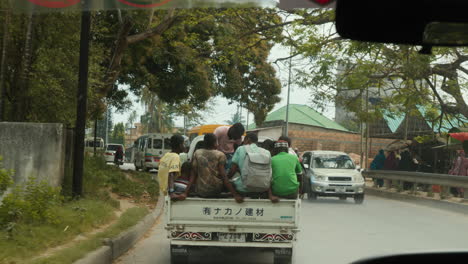 Locals-ride-in-the-back-of-a-pickup-truck-in-Zanzibar