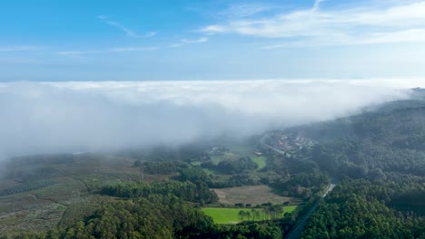 Aerial-View-Of-Foggy-Clouds-Over-Dense-Thicket-Near-Countryside-Town