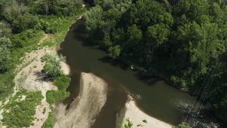 High-aerial-shot-of-Zumbro-river-in-Oronoco,-unrecognizable-people-swimming
