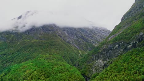 Aerial-along-the-cloud-covered-high-valleys-near-Hjelledalen,-Norway