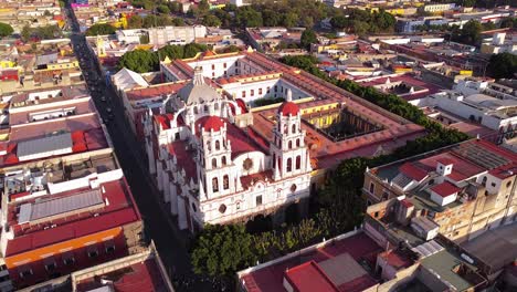Aerial-drone-backward-moving-shot-over-Parish-of-the-Holy-Guardian-Angel-of-Analco-or-temple-of-Analco-in-Puebla-city,-Puebla,-Mexico-during-morning-time