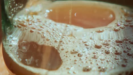 Close-Up-of-Pressed-Apple-Juice-Flowing-into-a-Glass-with-some-Foam