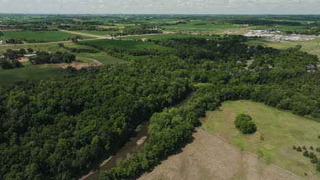 High-aerial-of-Zumbro-river-middle-fork-surrounded-by-forest-trees-in-Oronoco