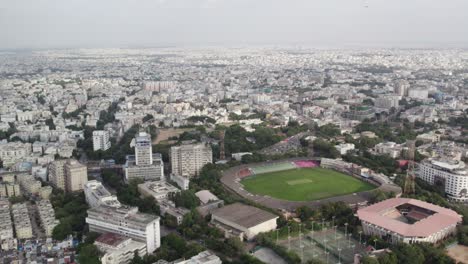A-cinematic-aerial-video-shows-Egale-flying-towards-a-cricket-stadium-in-Hyderabad,-close-to-the-Birla-Science-Museum-and-Birla-Planetarium