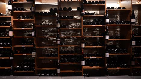 French-wine-cellar-in-a-local-hotel-restaurant-showing-a-variety-of-champagne-and-regular-bottles,-Dolly-in-shot
