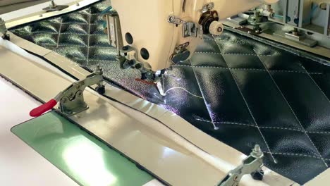 Hands-threading-an-automatic-sewing-machine.-Textile-industry