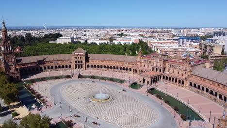 Aerial-View-Of-People-Walking-In-The-Plaza-de-España-On-A-Sunny-Day-In-Seville,-Spain