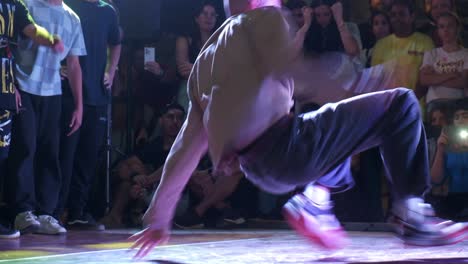 Young-man-showing-his-breakdance-skills-and-techniques-in-front-of-crowd