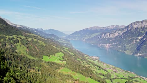 Cinematic-aerial-establishing-shot-of-Lake-Walensee-in-verdant-valley