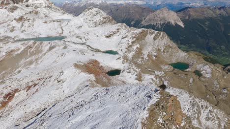Small-glacial-lakes-on-top-of-lightly-snow-capped-mountain-Cima-Fontana