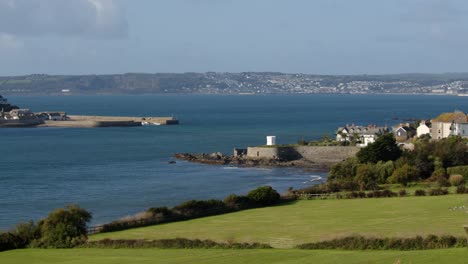 wide-panning-shot-of-St-Michael's-mount-with-the-village-of-Marazion-right-of-frame
