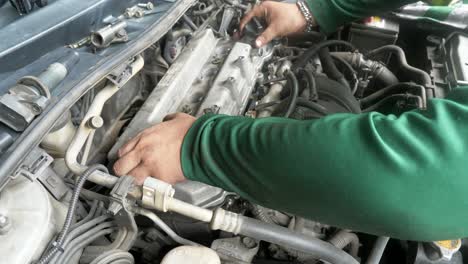 Mechanic-expertly-assembles-cylinder-headcover-of-a-car-engine