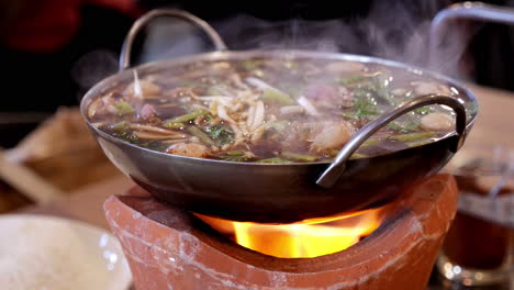 Cooking-spicy-oxtail-noodle-soup-on-a-firewood-stove