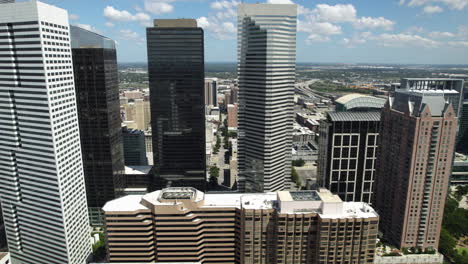 Panoramic-drone-shot-of-skyscrapers-in-the-city-center-of-sunny-Houston,-USA