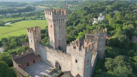 Aerial-orbit-of-Castello-Scaligero-turreted-towers-in-Borghetto-Verona-Italy
