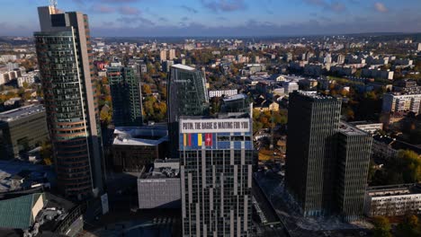 Vilnius-modern-business-skyscapers-aerial-with-Putin-anti-war-banner
