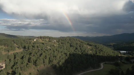 Architectures-On-Evergreen-Mountains-With-Rainbow-In-The-Background-Near-Colorado,-United-States