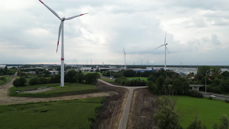 City-area-with-wind-turbines,-aerial-drone-view