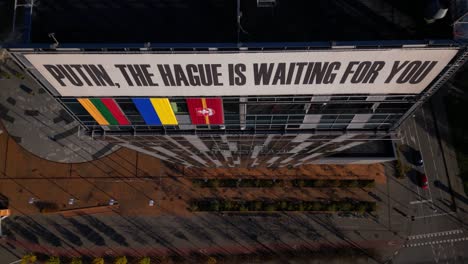 Flying-over-Putin-The-Hague-is-waiting-for-you-anti-war-sign-protest-banner