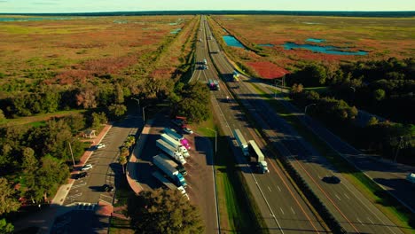 Stunning-aerial-view-of-highway-full-of-semi-trucks-due-to-trucking-business-industry