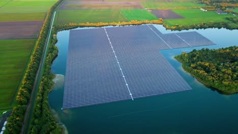 Big-Solar-Farm-on-Lake-Water-Generating-Sustainable-Energy,-Approaching-Aerial