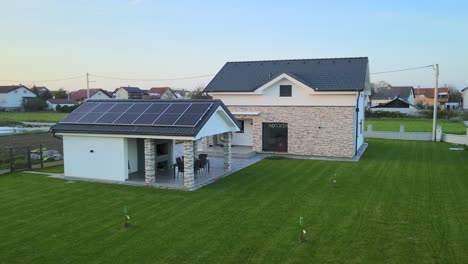Aerial-view-of-a-suburban-house,-smart-home-powered-by-photovoltaic-solar-cells