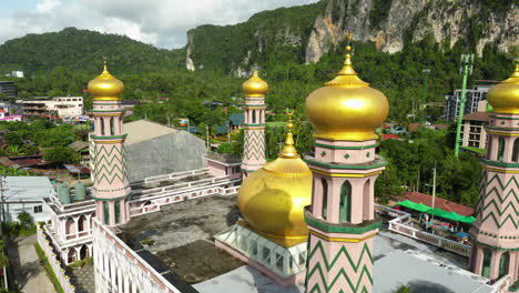 Aerial-orbiting-shot-of-golden-cupola-at-Asian-mosque-in-Ao-Nang,-Thailand