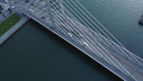 Aerial:-Cars,-street-tram-cross-cable-stayed-Crusell-Bridge,-Helsinki