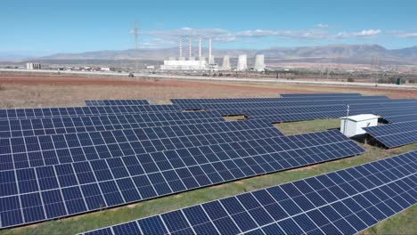 Drone-photovoltaic-solar-panel-park-with-Coal-fired-power-station-in-background