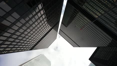 Toronto-skyscrapers-from-ground-perspective-against-cloudy-sky
