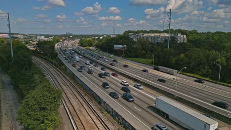 Drone-shot-showing-busy-multi-lane-highway-in-Atlanta-City-during-sunny-sky