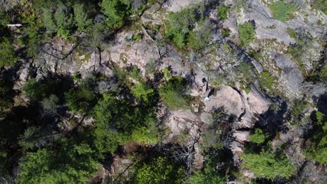 Aerial:-rocky-terrain-and-green-trees-in-Killarney-Provincial-Park,-Canada