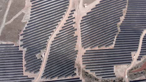 Top-down-view-photovoltaic-solar-power-park-farm-row-panels-rural-sunny-day
