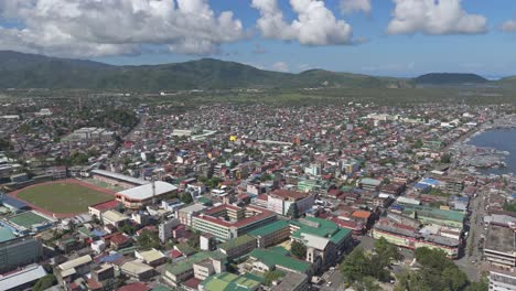 Panoramic-shot-of-the-entire-city-of-Surigao-in-Mindanao,-Philippines,-aerial-panning