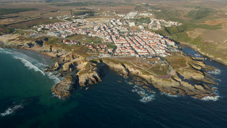 Aerial-view-of-the-coastal-town-of-Porto-Covo,-Portugal