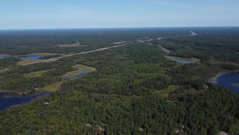 Aerial:-Grundy-Lake-Provincial-Park,-dense-forests,-and-winding-waterways