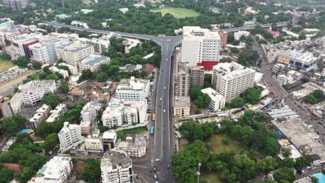 Aerial-drone-camera-is-flying-over-Rajkot-city-and-vehicles-are-seen-descending-from-the-fly-over-bridge