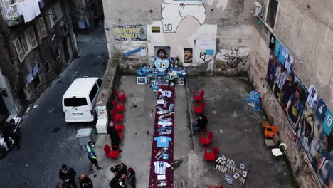 Memorial-of-Naples-football-player-in-narrow-city-street,-aerial-view