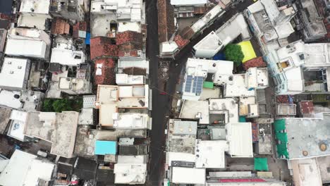 Aerial-drone-camera-moving-forward-above-the-street-market-showing-old-buildings