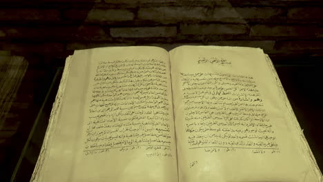 Ancient-Book-About-Medicine-From-Islamic-Golden-Age-With-Open-Pages-on-Display-in-Museum-of-Scholars,-Khiva,-Uzbekistan