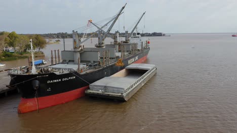 Self-unloading-bulk-carrier-Daiwan-Dolphin-cargo-hatches-open-unloading-sugar-in-port-of-Fray-Bentos