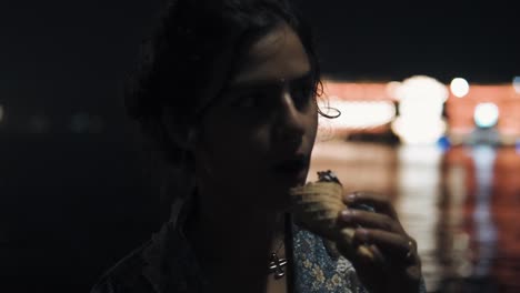 Indian-girl-with-silver-jewelry-eats-ice-cream-at-night