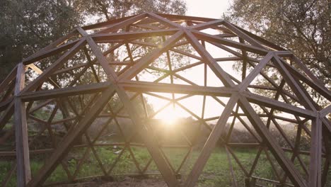 Mid-shot-of-wooden-hexagonal-geodome-structure-outdoors
