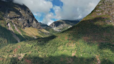 Aerial-hyperlapse-shot-of-a-Norvegian-mountain-valley-with-clouds-whirling-over-the-tops