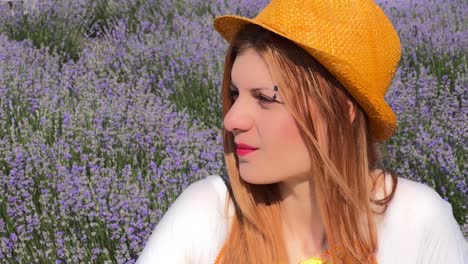 Side-profile-headshot-of-young-woman-with-eyebrow-piercing-and-orange-hat-against-lavender-field,-reflecting-on-life