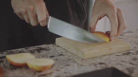 Person-Slices-Fresh-Juicy-Apple-On-Wooden-Chopping-Board