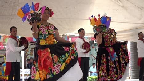 Slow-motion-shot-of-men-and-women-dancing-in-traditional-clothing-at-the-Guelaguetza